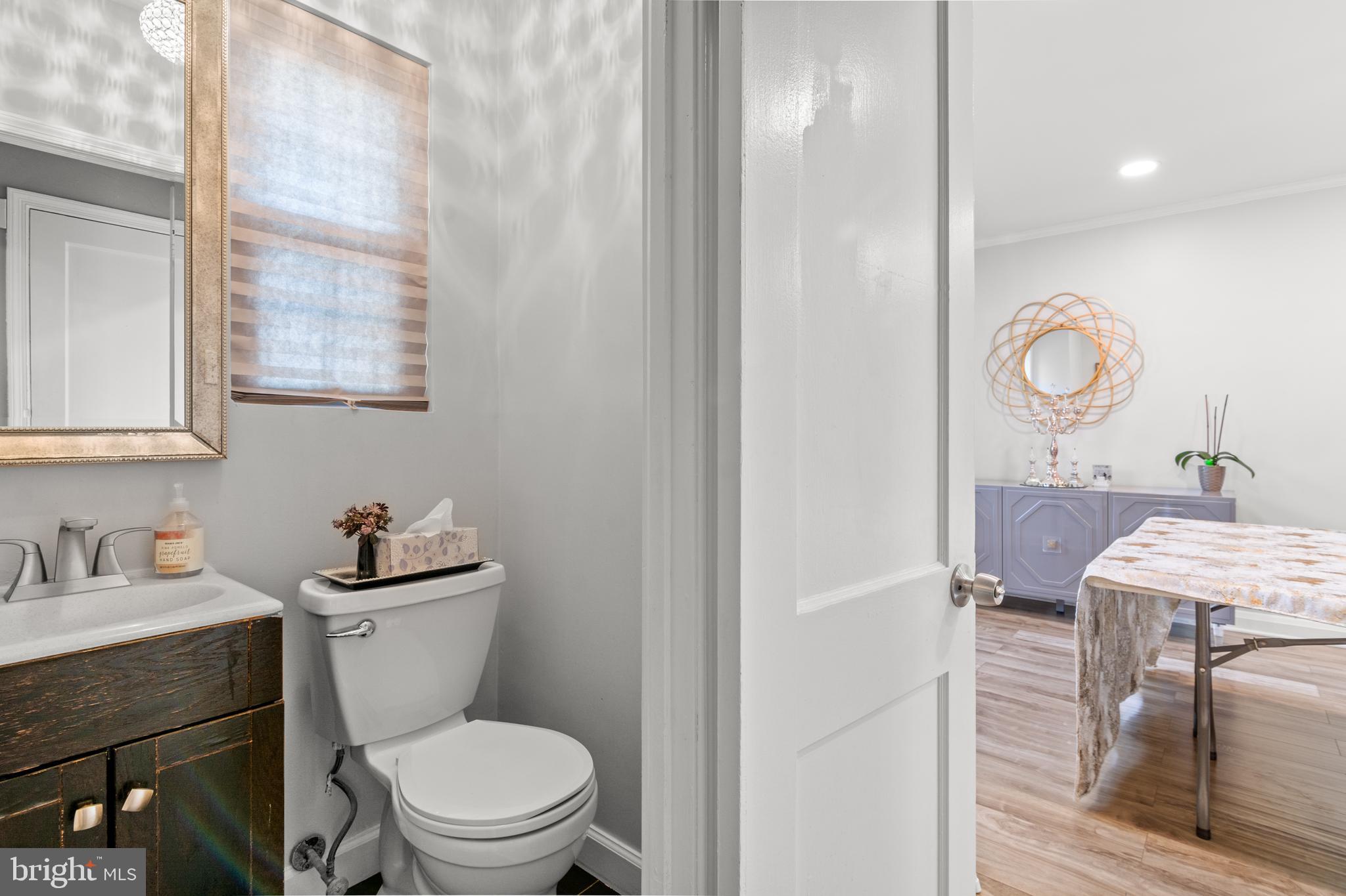 3302 Northbrook Road Baltimore, MD 21208 - Photo 13 of 35 a bathroom with a toilet a sink and mirror