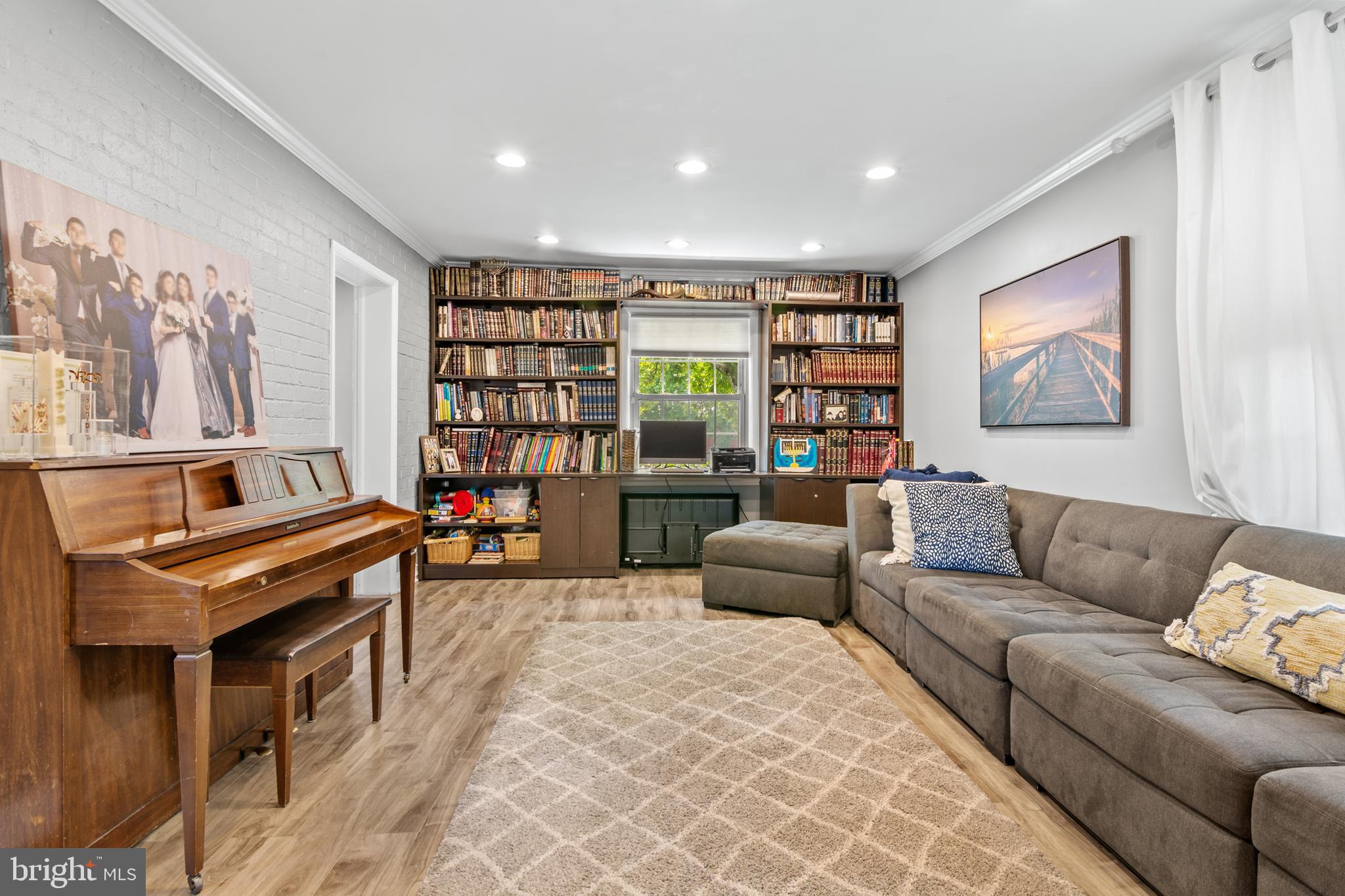 3302 Northbrook Road Baltimore, MD 21208 - Photo 3 of 35 a living room with furniture a piano and a bookshelf