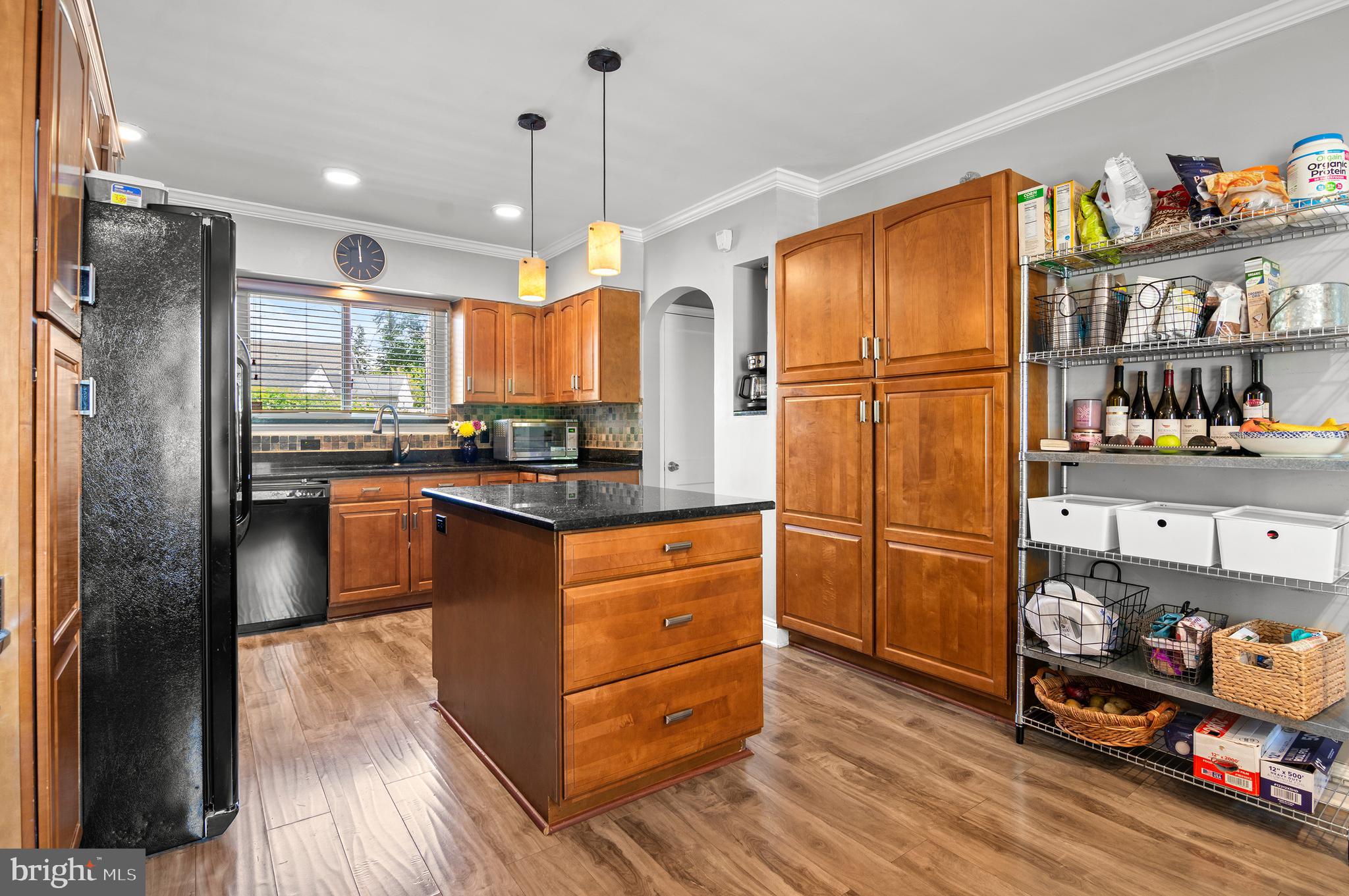 3302 Northbrook Road Baltimore, MD 21208 - Photo 8 of 35 a kitchen with stainless steel appliances granite countertop a refrigerator and a wooden floor