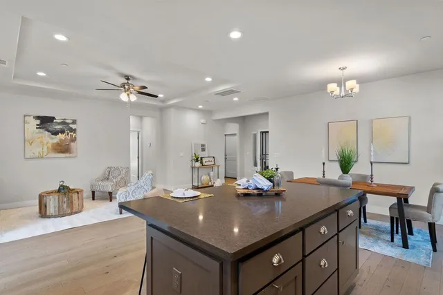a view of a dining room with furniture and a chandelier