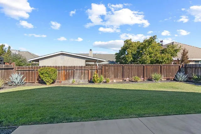 a view of a house with backyard and porch