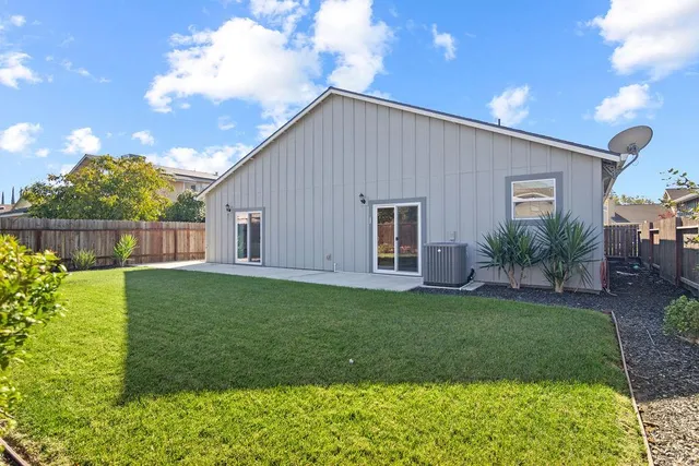 a view of a backyard with plants and a garden