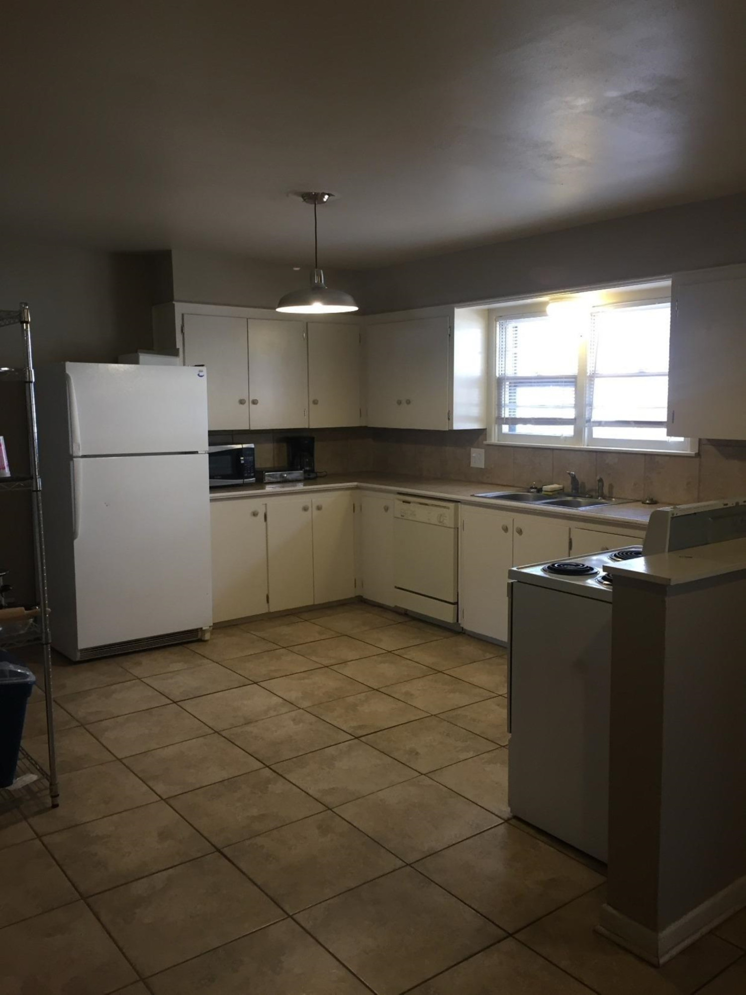 3216 36th Street Lubbock, TX 79413 - Photo 5 of 11 a kitchen with stainless steel appliances granite countertop a sink and a refrigerator