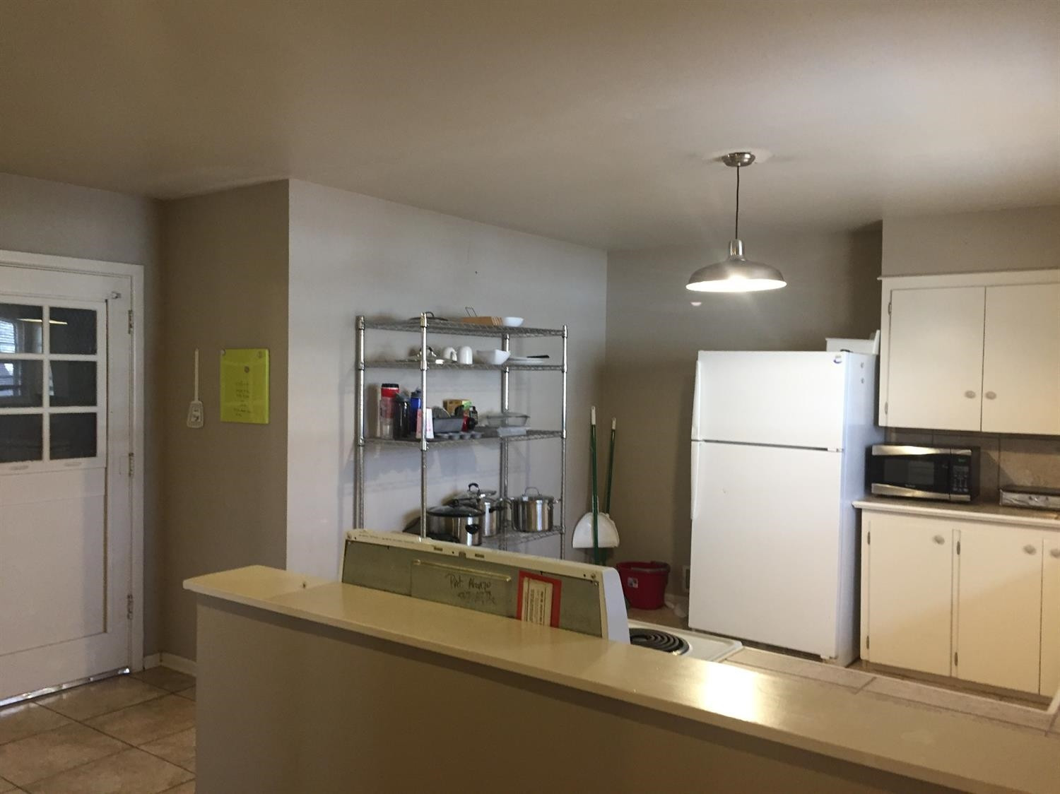 3216 36th Street Lubbock, TX 79413 - Photo 6 of 11 a kitchen with stainless steel appliances a refrigerator a sink a stove and a refrigerator