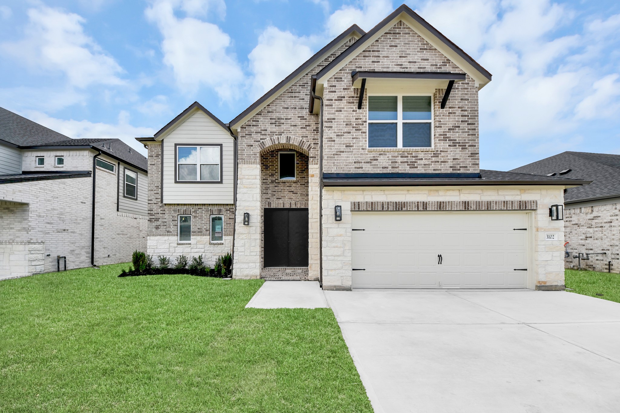3102 Native Spg Drive Spring, TX 77373 - Photo 3 of 47 This home boasts lush green grass and meticulous landscaping. Its premium elevation showcases an exquisite blend of brick and stone features, complemented by modern coach lighting
