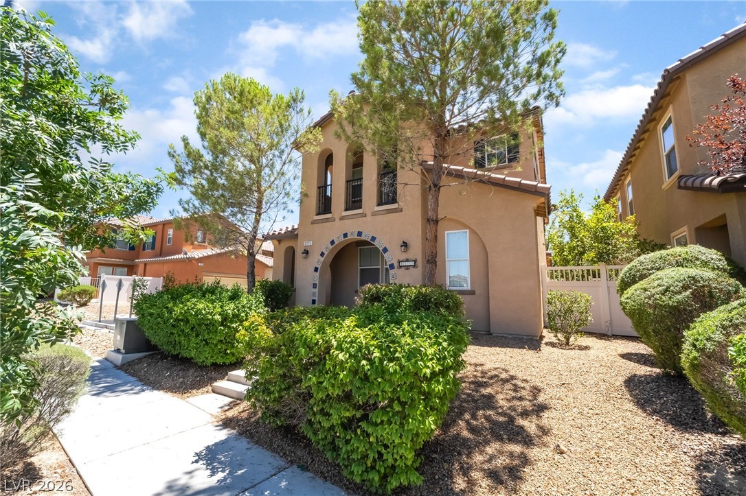 3175 Via Seranova Henderson, NV 89044 - Photo 4 of 45 This charming residence features an inviting arched entrance, surrounded by lush, mature landscaping and a tiled roof.