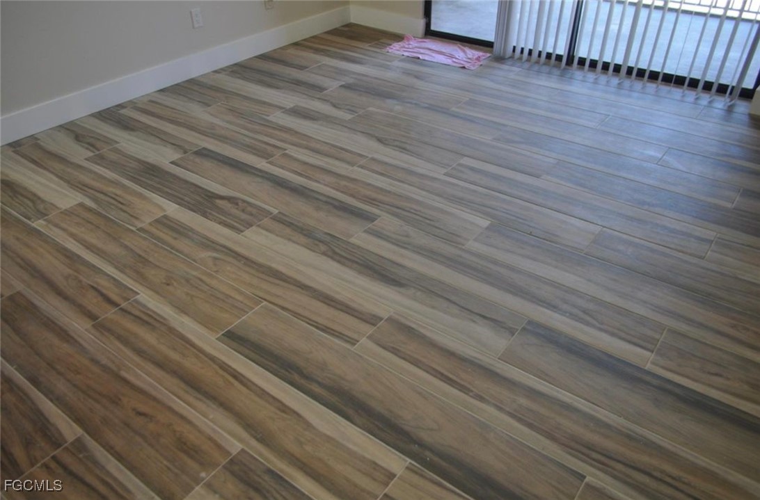 13521 Eagle Ridge Drive, Unit 128 Fort Myers, FL 33912 - Photo 4 of 11 a view of backyard with wooden floor