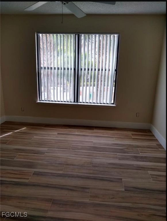 13521 Eagle Ridge Drive, Unit 128 Fort Myers, FL 33912 - Photo 6 of 11 a view of a room with wooden floor and a window