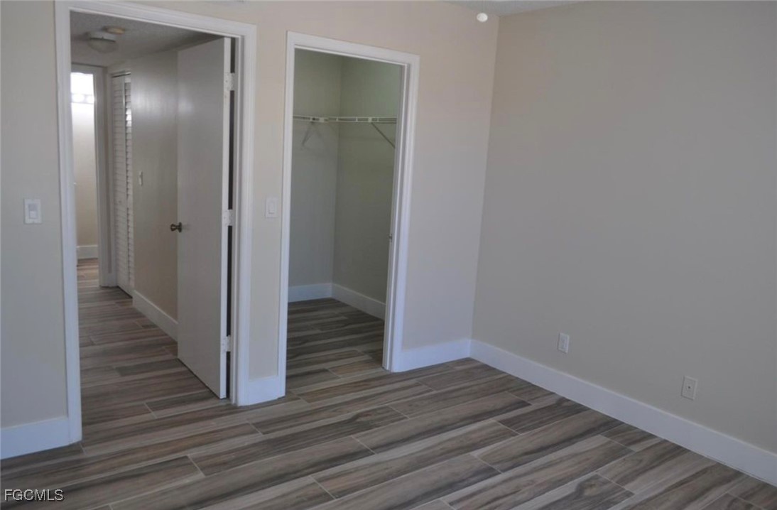 13521 Eagle Ridge Drive, Unit 128 Fort Myers, FL 33912 - Photo 7 of 11 a view of a hallway with wooden floor