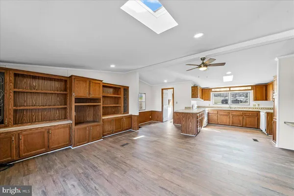 a kitchen with granite countertop cabinets stainless steel appliances a sink and a window