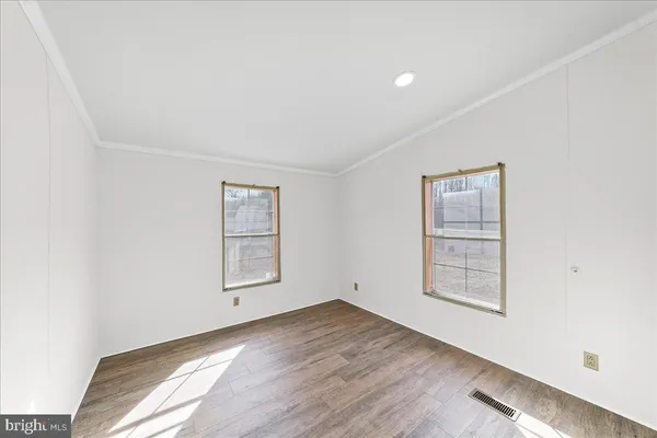 a spacious bathroom with a toilet sink and mirror
