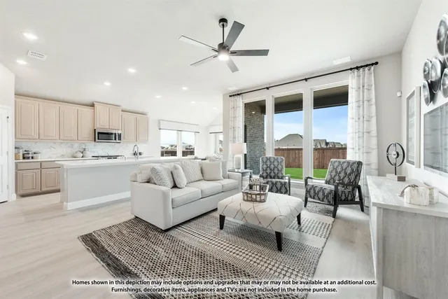 a living room with furniture appliances and a large window