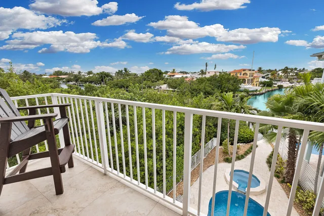 a spacious bedroom with a table and a potted plant