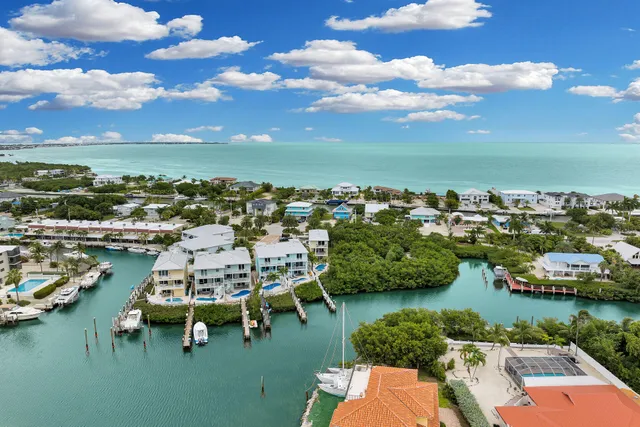 an aerial view of a house with a ocean view