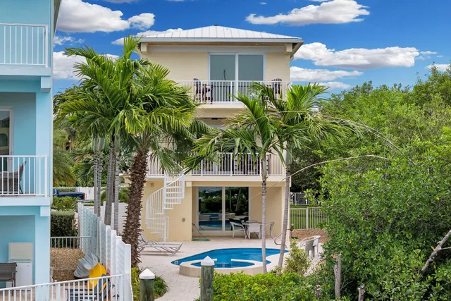 a view of a swimming pool with a patio and a garden