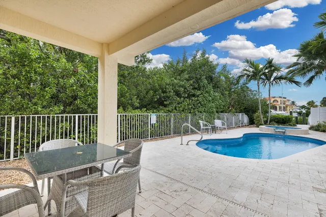 an aerial view of a house with a yard lake view and boat