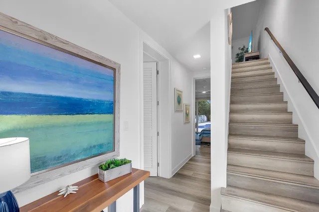 a view of a hallway with wooden floor and entryway
