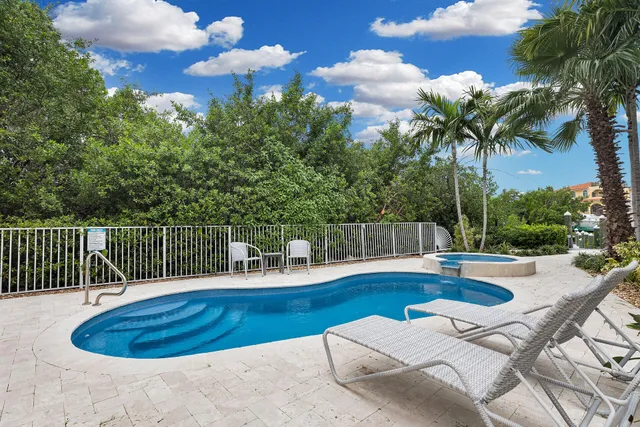 a view of a house with swimming pool and sitting area