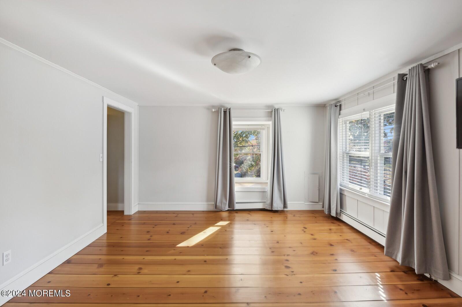 664 Carroll Fox Road Brick, NJ 08724 - Photo 28 of 63 a view of empty room with wooden floor and fan