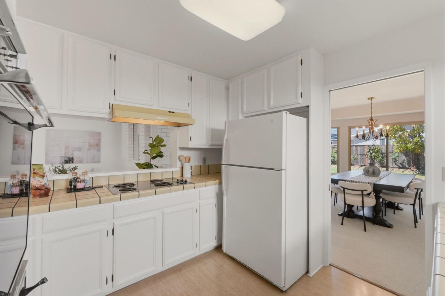 7577 Bollinger Road Cupertino, CA 95014 - Photo 16 of 56 a kitchen with white cabinets and white appliances