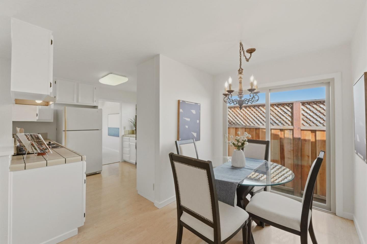 7577 Bollinger Road Cupertino, CA 95014 - Photo 23 of 56 a dining room with furniture and a chandelier