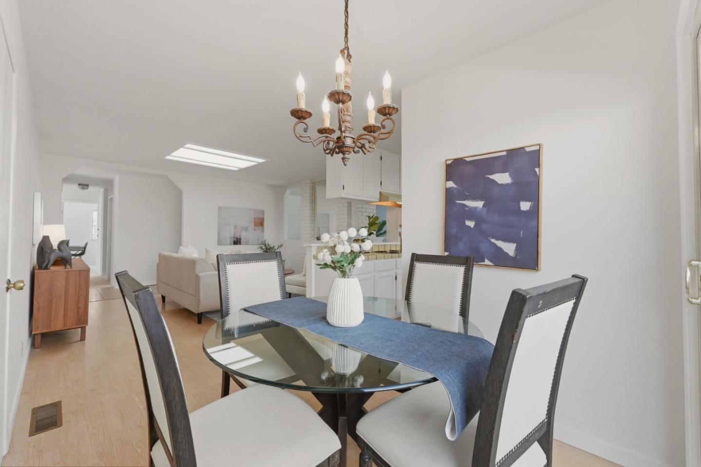 7577 Bollinger Road Cupertino, CA 95014 - Photo 26 of 56 a dining room with furniture a chandelier and wooden floor