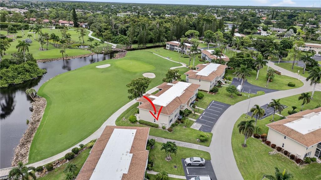 219 Memory Lane, Unit 3 Naples, FL 34112 - Photo 33 of 35 Drone / aerial view of pond and a golf course
