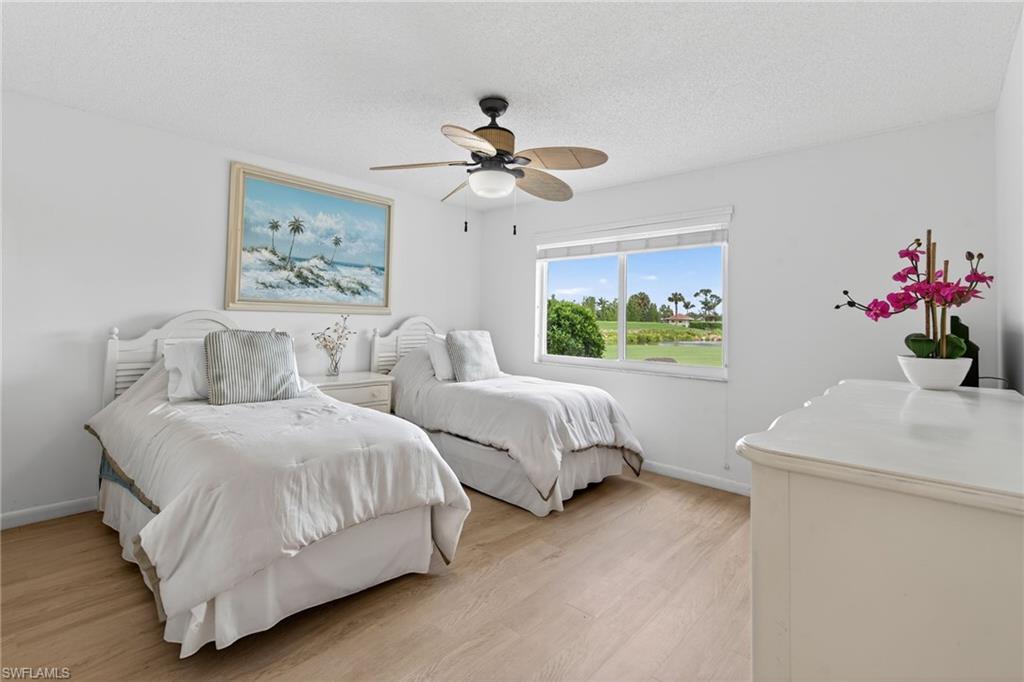 219 Memory Lane, Unit 3 Naples, FL 34112 - Photo 8 of 35 2nd bedroom with new floors and ceiling fan