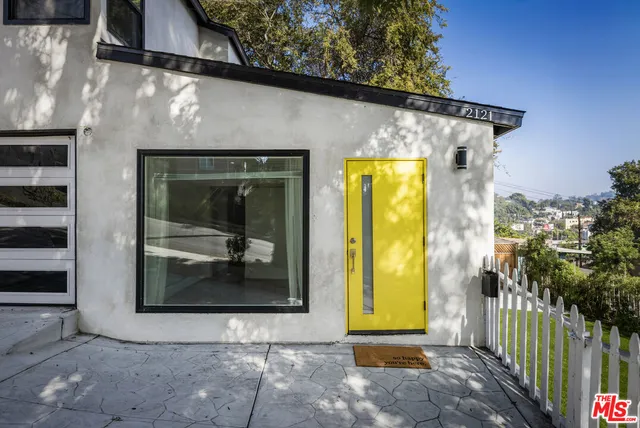 a view of a house with a door and wooden floor
