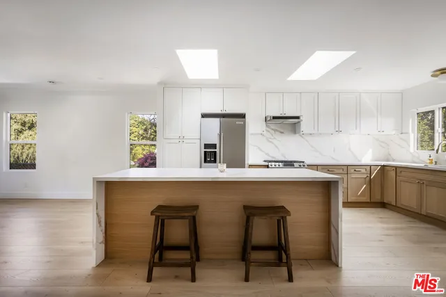 a kitchen with a sink cabinets and window