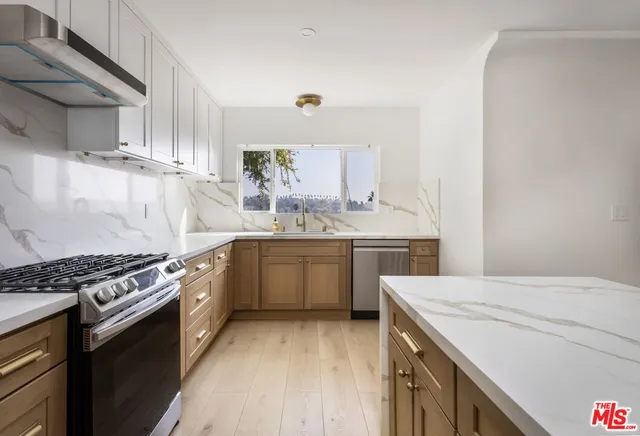 a kitchen with a sink stove top oven and cabinets