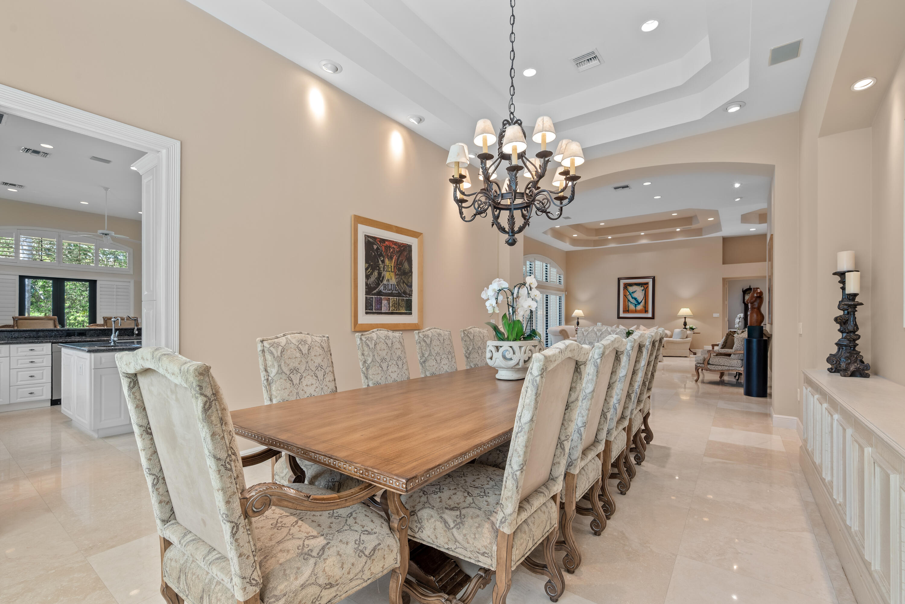 18800 Long Lake Drive Boca Raton, FL 33496 - Photo 15 of 60 a view of a dining room with furniture a chandelier and wooden floor