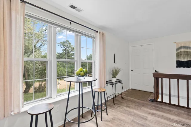 a view of a dining room with furniture window and wooden floor