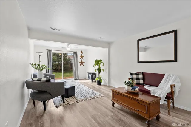 a living room with furniture and a potted plant