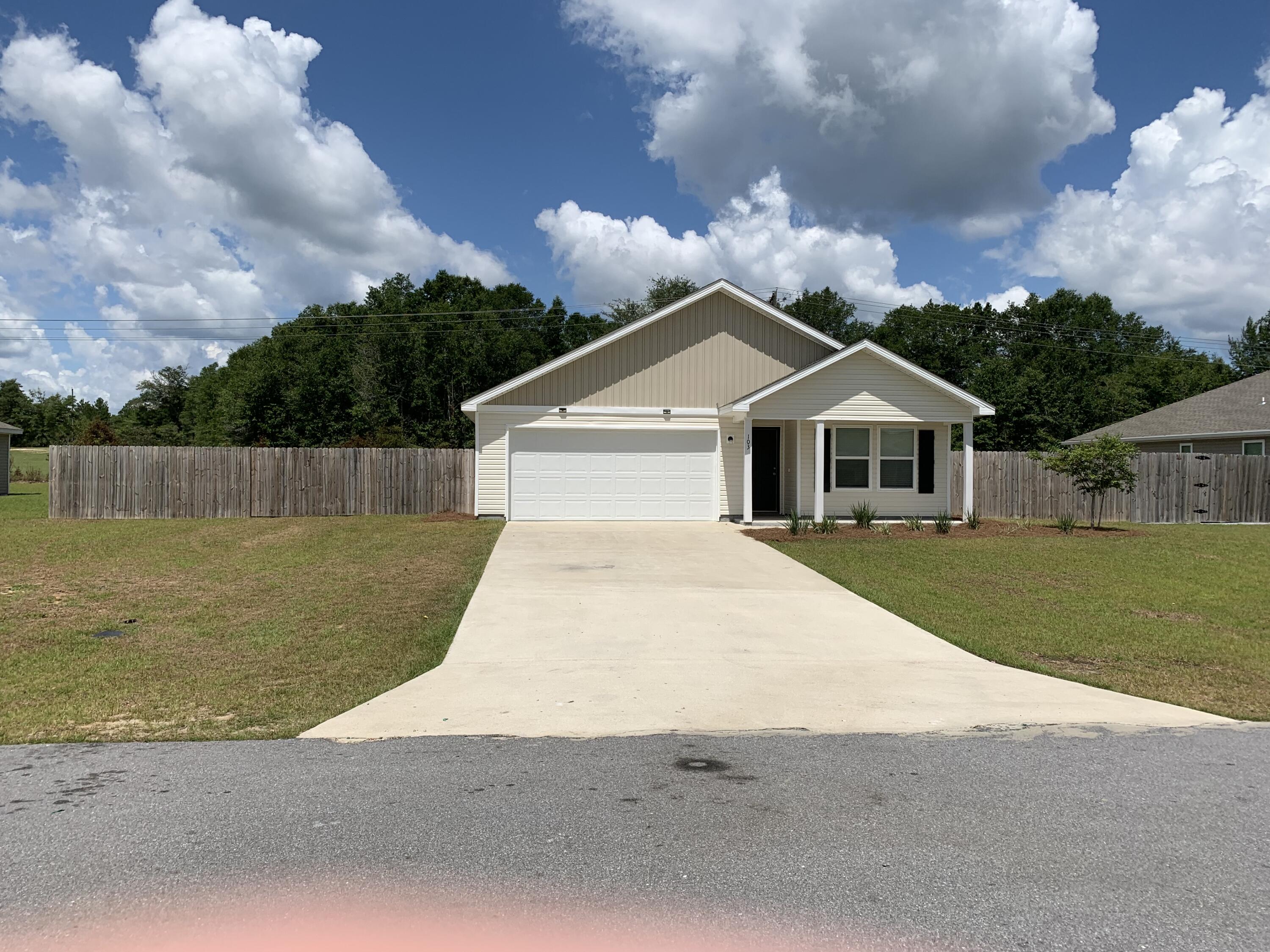 103 Cora Road DeFuniak Springs, FL 32433 - Photo 23 of 72 a front view of a house with a garden
