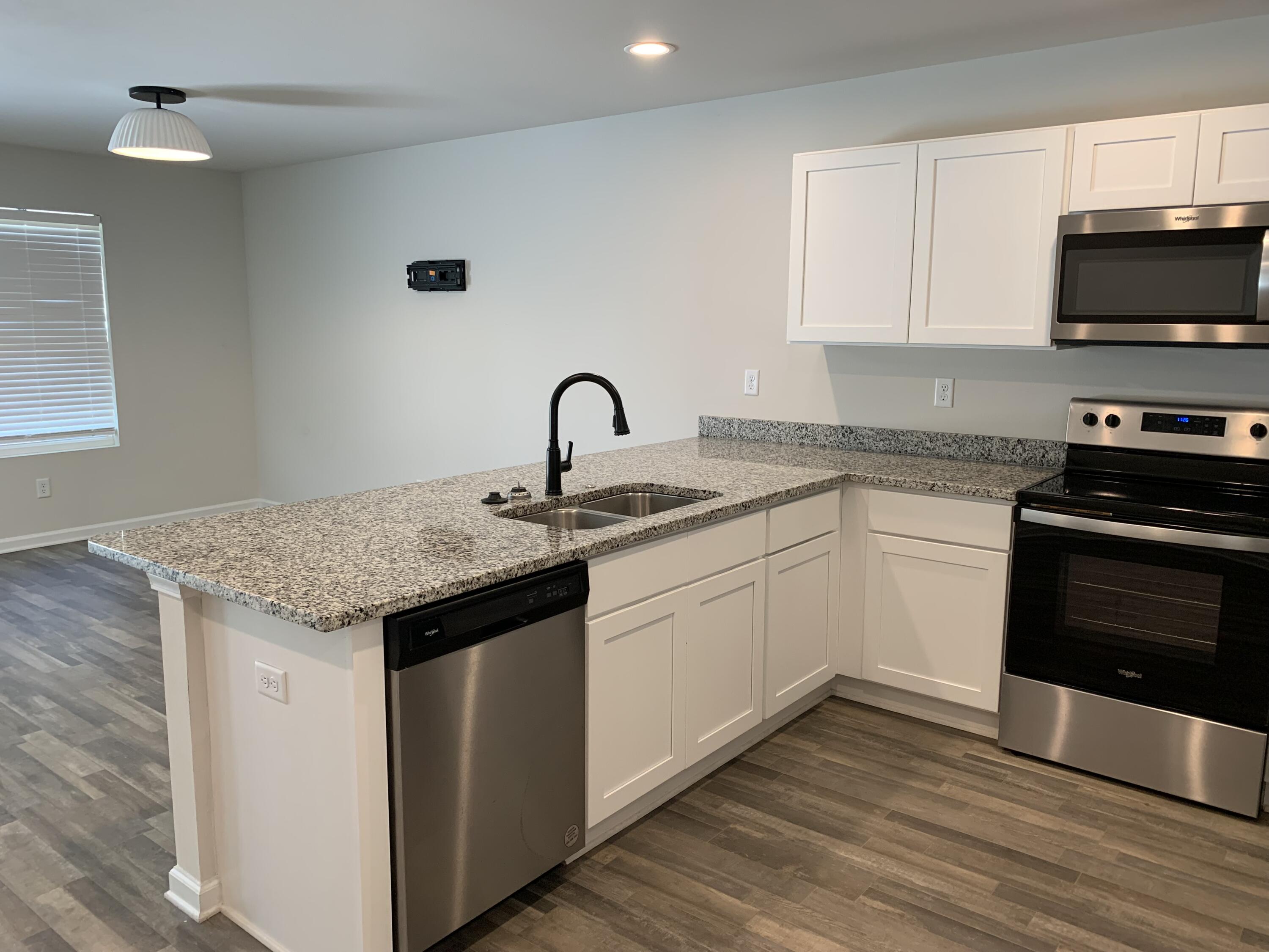 103 Cora Road DeFuniak Springs, FL 32433 - Photo 42 of 72 a kitchen with granite countertop a sink and a stove top oven