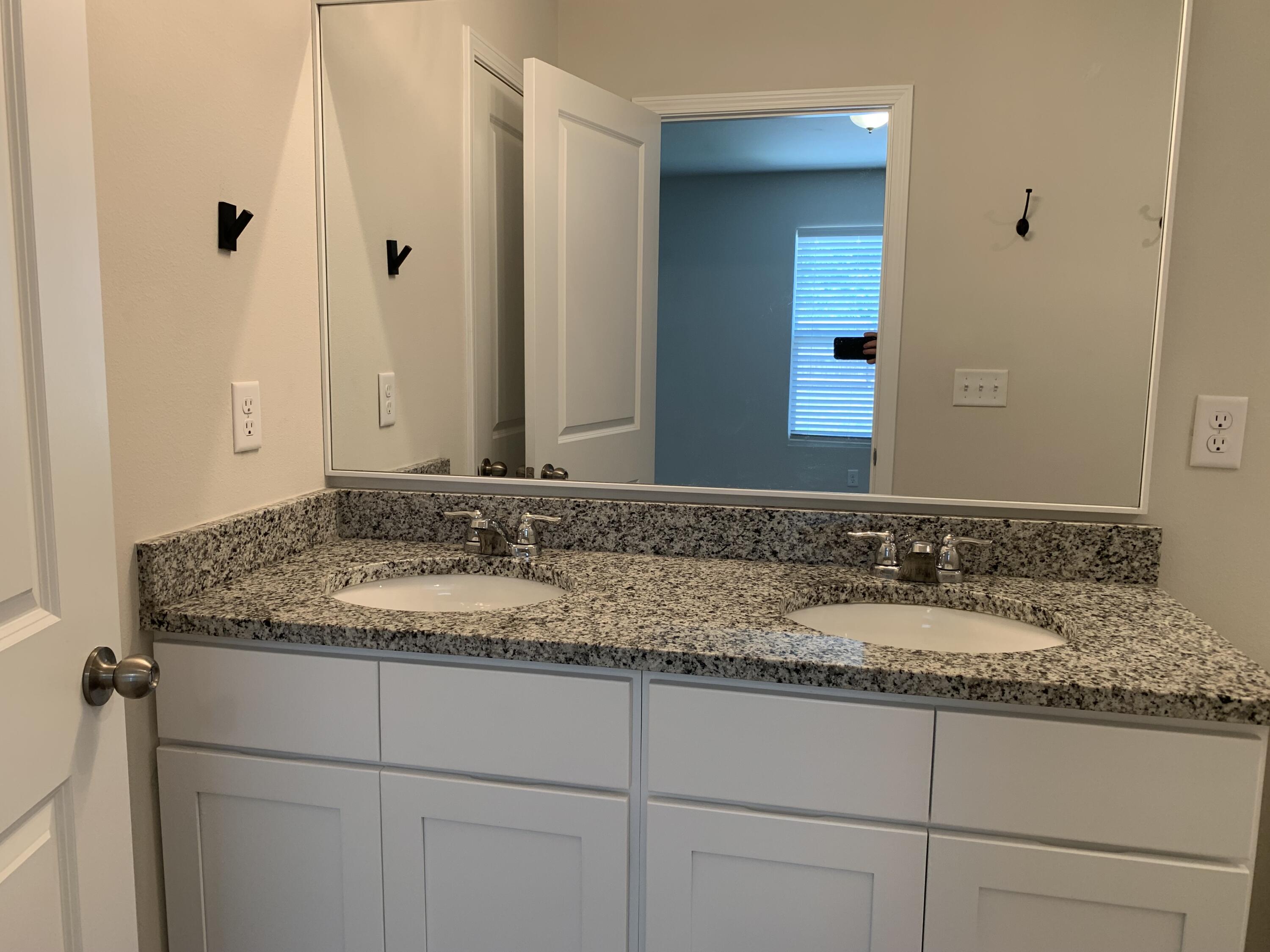 103 Cora Road DeFuniak Springs, FL 32433 - Photo 50 of 72 a bathroom with a granite countertop sink and a mirror