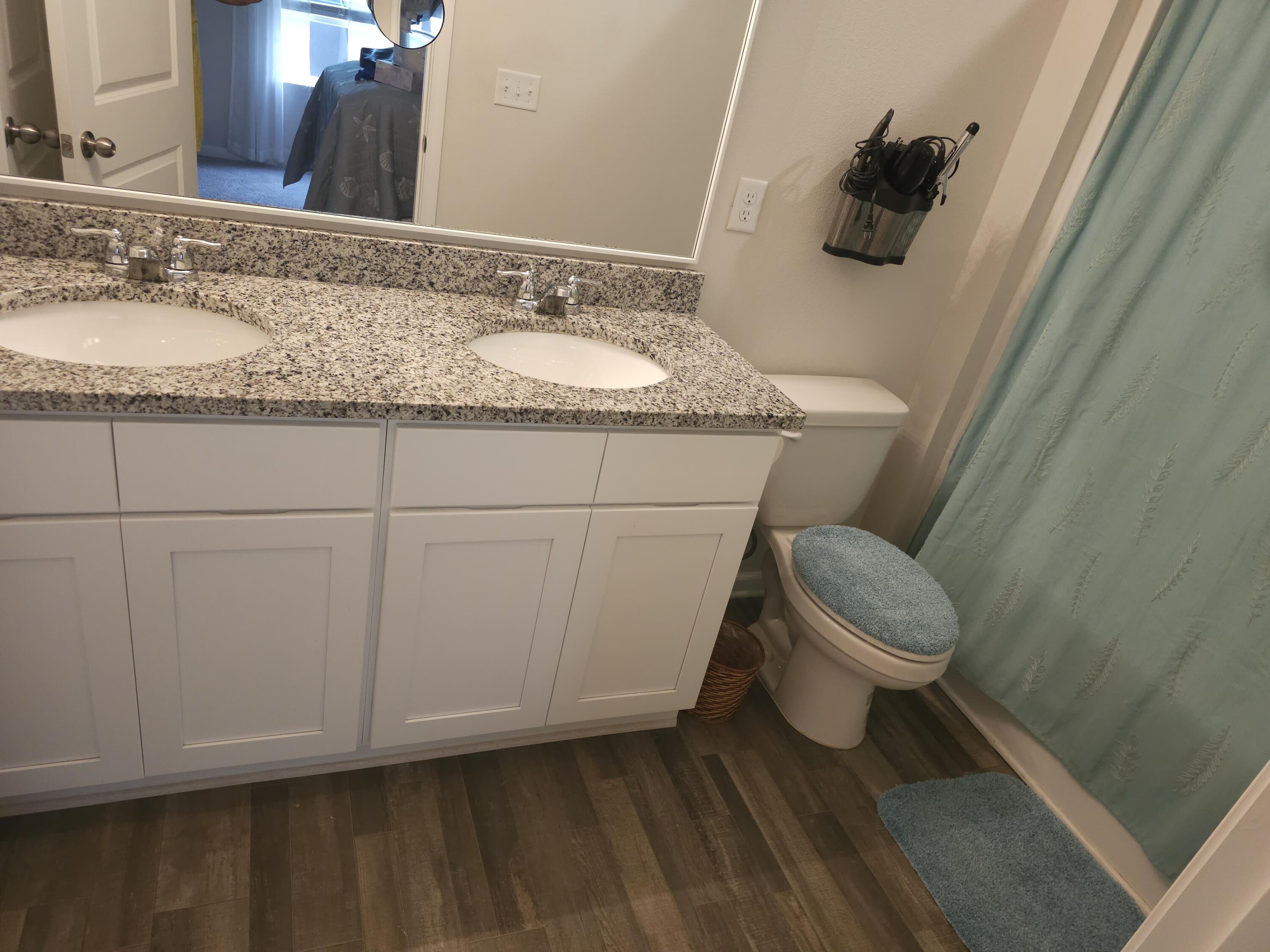 103 Cora Road DeFuniak Springs, FL 32433 - Photo 61 of 72 a bathroom with a granite countertop sink toilet and vanity