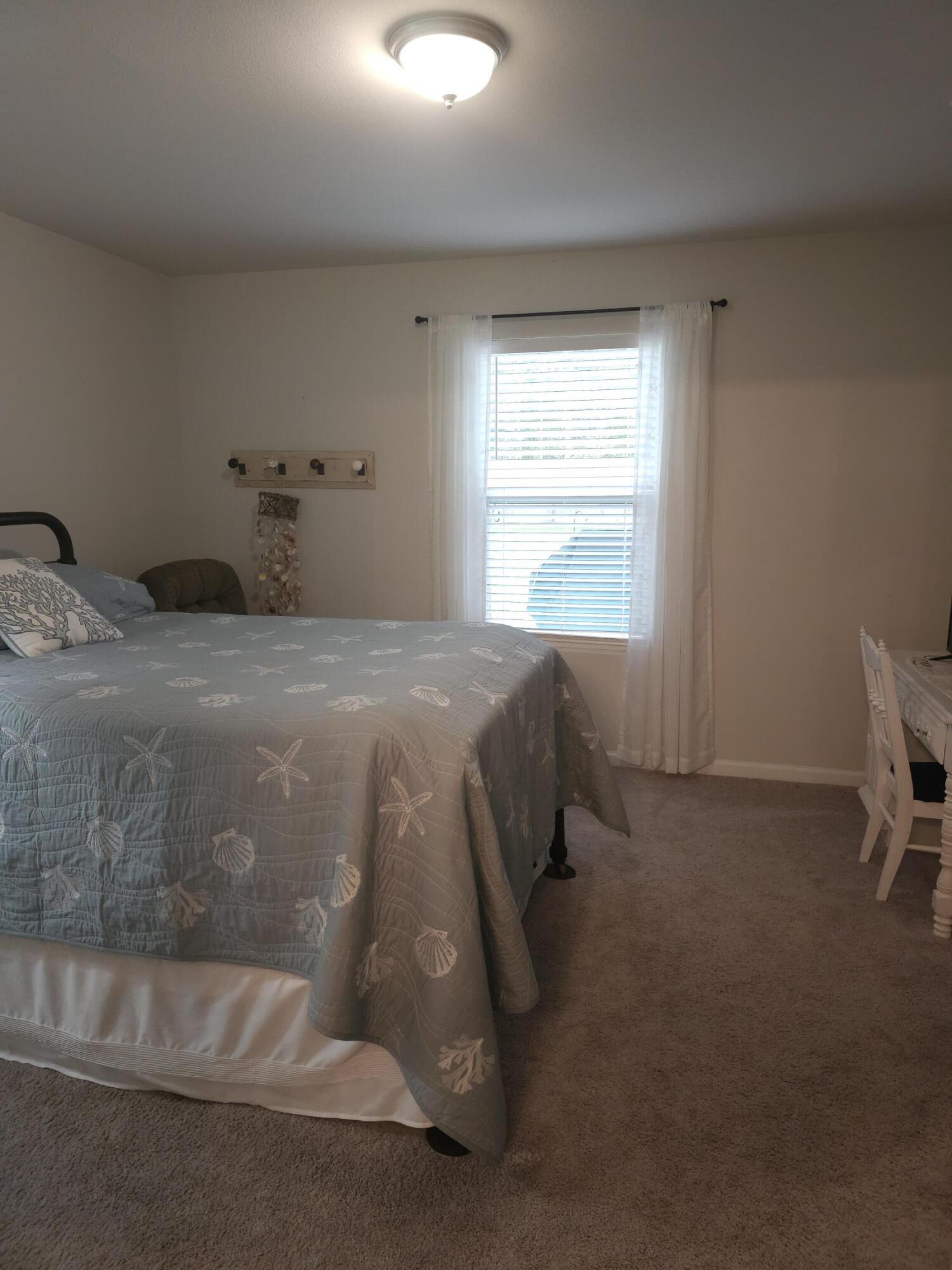 103 Cora Road DeFuniak Springs, FL 32433 - Photo 65 of 72 a bedroom with a bed and a window
