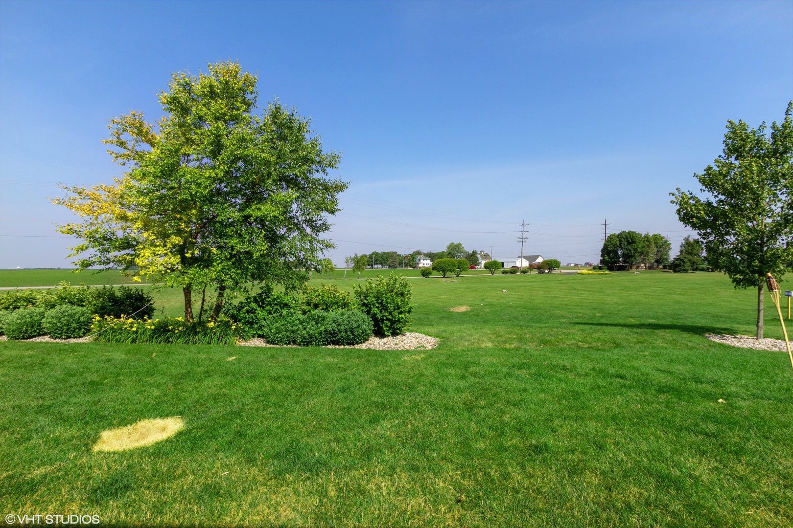 25109 Faraday Road Manhattan, IL 60442 - Photo 11 of 12 a view of a grassy field with an trees