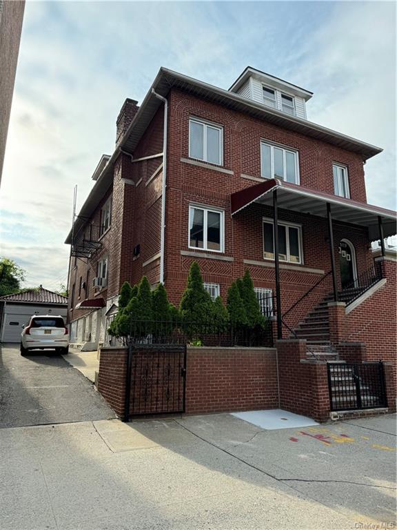 3179 Rochambeau Avenue Bronx, NY 10467 - Photo 1 of 7 View of side of property featuring a garage