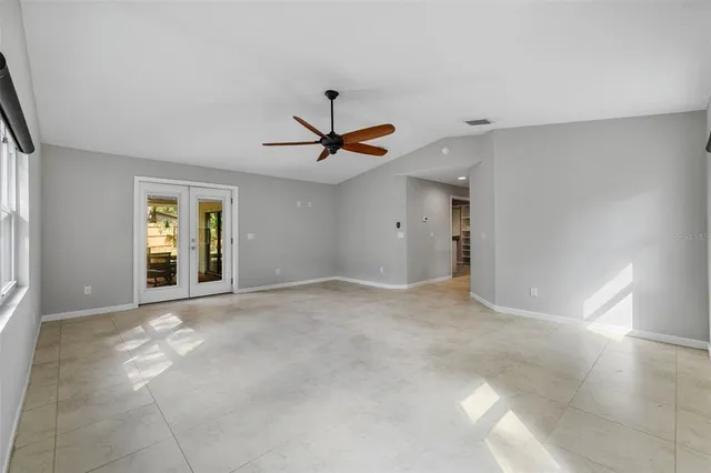 a view of a livingroom with a ceiling fan and window