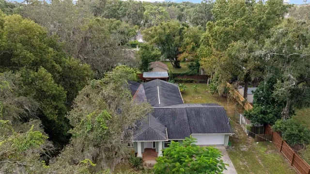 an aerial view of a house with a lake view