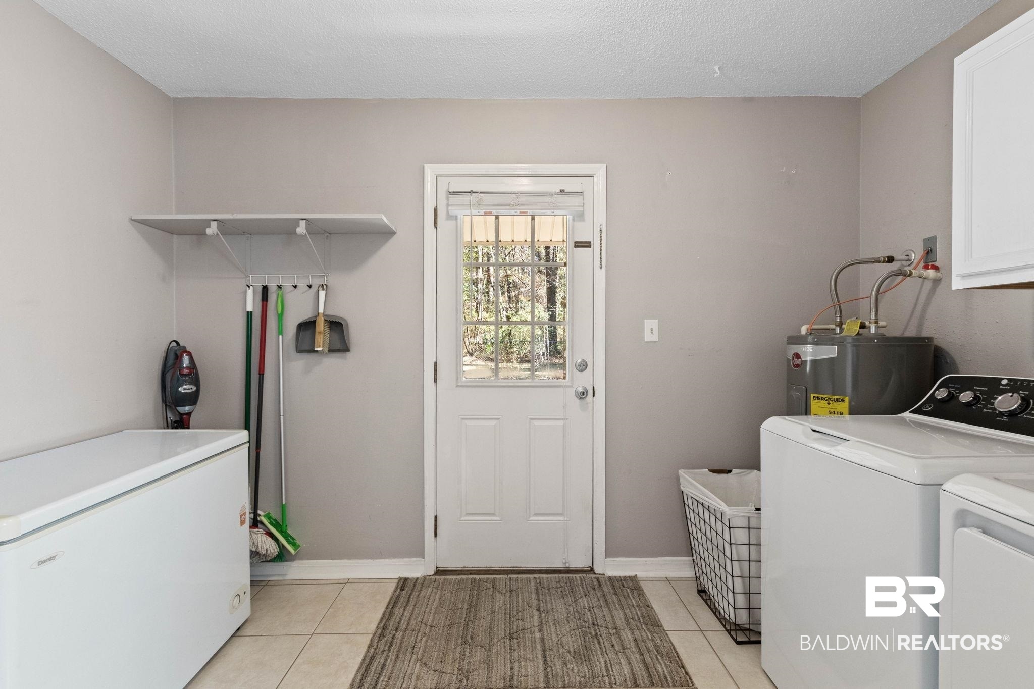 5366 Scanlan Way West Satsuma, AL 36572 - Photo 27 of 43 Laundry area featuring washer and clothes dryer, light tile patterned floors, a textured ceiling, and electric water heater