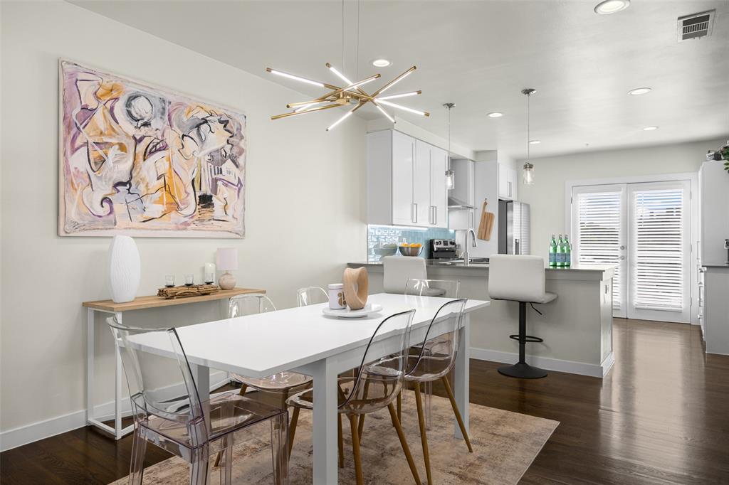 3922 Gilbert Avenue, Unit 214 Dallas, TX 75219 - Photo 5 of 27 Open-concept living space featuring wood-finish flooring, a contemporary linear chandelier, and recessed lighting