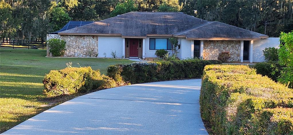 1804 East Wheeler Road Seffner, FL 33584 - Photo 1 of 25 a front view of a house with garden