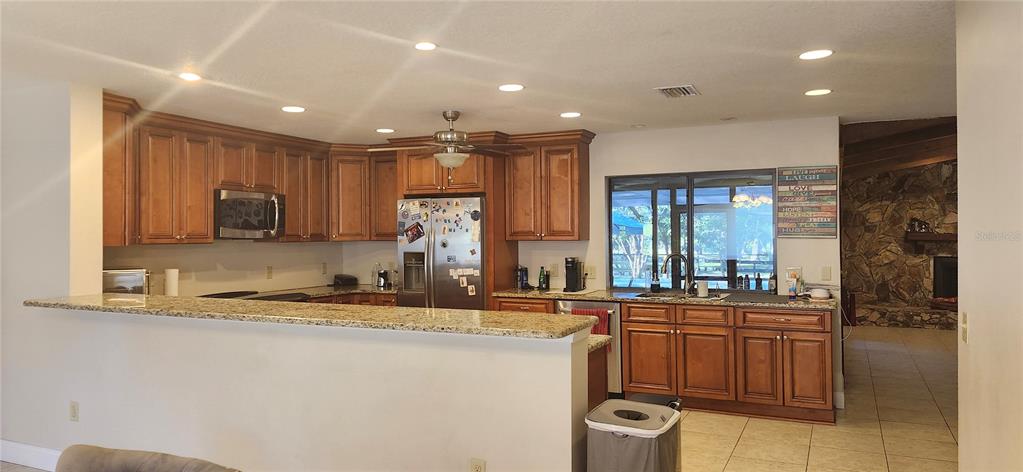 1804 East Wheeler Road Seffner, FL 33584 - Photo 15 of 25 a kitchen with stainless steel appliances granite countertop a sink a stove and a refrigerator