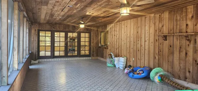 a view of a patio with a table chairs and a floor to ceiling window