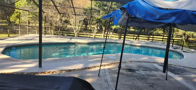 a bathroom with a granite countertop shower sink and mirror