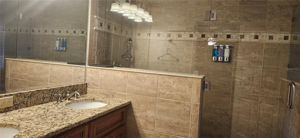 1804 East Wheeler Road Seffner, FL 33584 - Photo 23 of 25 a bathroom with a granite countertop shower sink and mirror